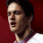 Static pixelated image of a person's face and upper neck against a solid red background, with visible dithering and color blending artifacts in the rendering.
