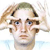 Pixelated image of a person with light brown hair, blue eyes, and a neutral expression, set against a white background with faint blue accents.