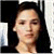 Static pixelated image of a person with dark hair against black and white background elements.