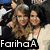 Two women pose together in a crowd; one has long brown hair, the other dark curly hair, both wearing light-colored tops.