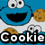 Pixelated blue Cookie Monster with large white eyes and black pupils, smiling with a black mouth, holding a brown cookie with chocolate chips, next to a smaller cookie with pink cheeks and a smile on a pink background.