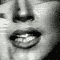 A black-and-white animated sequence showing a person's mouth and nose with a toothbrush in various positions during brushing.