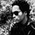 Black-and-white photo of a person with dark hair and sunglasses on the left, next to text reading Lenny Kravitz in white, LOVE in red, REVO- LUTION in red, and AVAILABLE NOW in white on a black background.