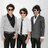 Three men in formal attire stand side-by-side against a light background with green and gray containing text