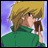 Pixelated anime-style character with blonde hair and green jacket holding brown object near face against purple background.