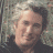 A pixelated image of a person with light-colored hair against a textured background, next to green text reading 'Original Icons .com' on dark green.