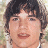 A pixelated image of a person with dark hair and light skin, next to green text reading 'OriginalIcons.com' on a solid background.
