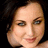 Static pixelated image of a person's face with dark hair, light skin tone, and visible eyes nose mouth against black background.