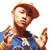 Pixelated static image of a person with reddish-brown hair wearing a blue shirt, making hand gestures against a white background.