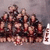 Group of cartoon characters in a pyramid formation with one character at the bottom, all standing on a gray background.