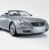 Pixelated silver sedan viewed from front-left angle, showing headlights, grille, and side mirror against light gray background.