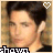 A pixelated portrait of a person with dark hair, wearing a black top, with a heart symbol above the head and text at the bottom.