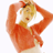Pixelated static image of a person with blonde hair wearing an orange top, arms raised behind head in a pose against white background.
