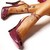 Pixelated image of two hands clasped together, one hand with a red sleeve and the other with a brown sleeve, against a white background.