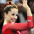 A 4x4 contact sheet of a gymnastics-themed animated icon showing sequential frames of a female gymnast in red leotards performing poses with text overlays, including
