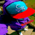 A character wearing a blue and red cap with white text, purple clothing, and brown shoes stands against a green background.