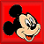 Pixelated cartoon icon of Mickey Mouse's head on a red background with black ears and beige face, mouth open showing tongue.