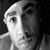 Black-and-white pixelated image of a person's face on left, stylized text 'G Unit' in white script font on right against black background.