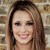 A static pixelated image of a person with long brown hair, light skin, and a smiling expression against a blurred background.