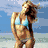 A woman in a light blue bikini stands on a beach with wind-blown hair, next to a Boston Red Sox logo and other icons.