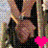 A pixelated image of a person in dark clothing with a bright pink heart symbol below, showing slight animation changes.