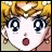 Pixelated anime-style face with blonde hair, large blue eyes, and open mouth on left; black background with white text 'Anime IM' and 'com' on right.