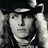 Black-and-white image of a person with long hair and a hat, accompanied by red text reading 'The Vampire Lestat' on black background.
