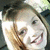 four pixelated images showing a person with light brown hair and white face, smiling widely in each frame