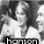 Black-and-white pixelated image of a person with long hair smiling, overlaid with the text 'hanson' in bold lowercase letters.