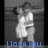 Pixelated grayscale image of a figure in a white dress with arms raised, standing against a dark background with blue text reading "I love you" at the bottom.