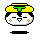 Pixelated cartoon head with yellow hair, green T-shaped accessory, white face, black eyes and mouth, orange cheek marks, black base on gray background.