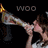 Animated sequence showing a person holding a megaphone with 'WOO' text above, transitioning through color variations of the text and character pose.