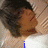 A person with dark hair lies on a light-colored patterned surface, with blue text appearing sequentially below them.
