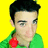 Pixelated portrait of a person with short black hair against bright yellow background, wearing green garment with red accent on left shoulder.