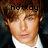 Pixelated close-up of a person with light brown hair wearing a white shirt and dark jacket, with black text overlay reading 'hottoy' above the head.