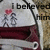 A static pixelated image shows two figures on a white background with text above them, one figure holding a red heart.