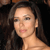 A static pixelated image shows a person with long dark hair, light skin, and a neutral expression against a dark background.
