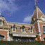 nine distinct amusement park structures including castles, bridges, and roller coaster elements under clear blue skies