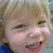 A composite image with a smiling child, a framed photo of a man, and text with pink hearts.