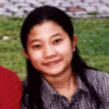 Two side-by-side static images of a person with long dark hair, one outdoors on grass, the other indoors with blurred background elements.