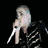 Animated sequence showing a person with white hair in three distinct poses: holding an object, smiling in green jacket, and static close-up.