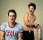 Animated sequence showing two men interacting with a large fish against a plain background, text overlay reads "the johnny knoxville fanlisting yes, it's a wet fish.".