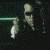 A pixelated animated sequence shows a figure in dark clothing holding a small white object against a dark background with light effects.