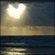 A static pixelated image shows a bright heart-shaped light source above a horizontal horizon line with water reflections below.