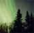 Pixelated landscape with dark silhouetted trees against a gradient sky transitioning from light green to dark gray.