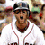 Four- of baseball player in white uniform with red accents, helmet, and text 'Yankees suck' on one