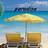 Pixelated static image of a beach scene with two lounge chairs under an umbrella on sandy shore, blue water and sky background.