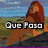 Pixelated image of a character with long brown hair sitting on grass, blue sky background, text overlay changes from 'Que Pasa' to 'Mucho?'