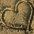 A static image with a heart-shaped sand drawing on the left and text on a bright pink background reading "You Are The MusicIn Me Boy <33".