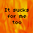 Pixelated text "It sucks for me too" on a fiery orange-yellow background with one gray